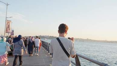 a man is taking pictures of the water and people
