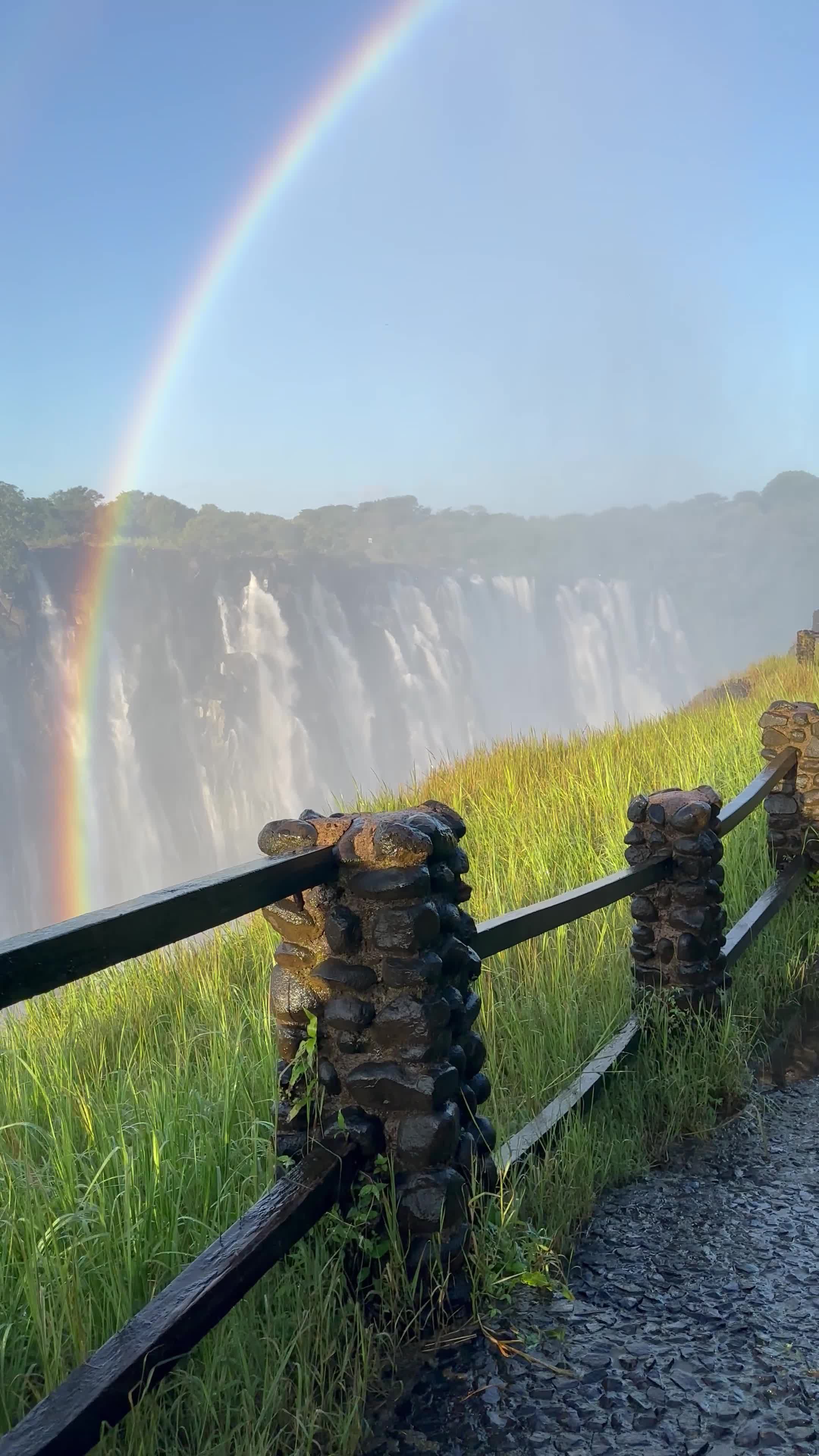 A path leading to a waterfall with grass and water Free Stock Video ...