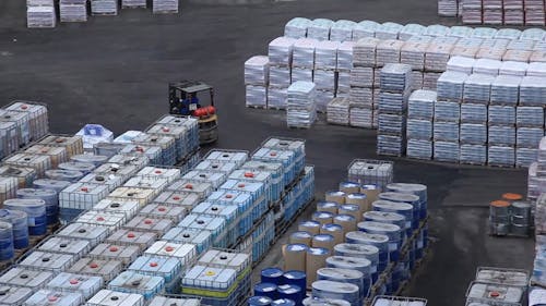 A Worker Transferring Goods In A Forklift