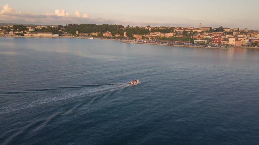 Aerial view of a vessel on open water, representative of maritime monitoring.