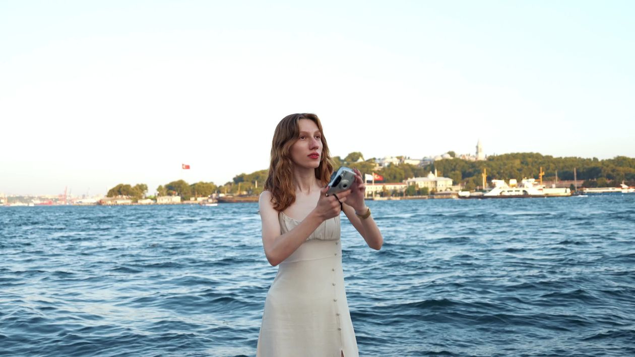 A woman in a white dress standing on the water Free Stock Video Footage ...