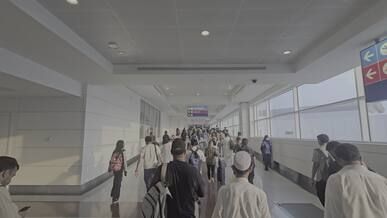 a group of people walking through an airport
