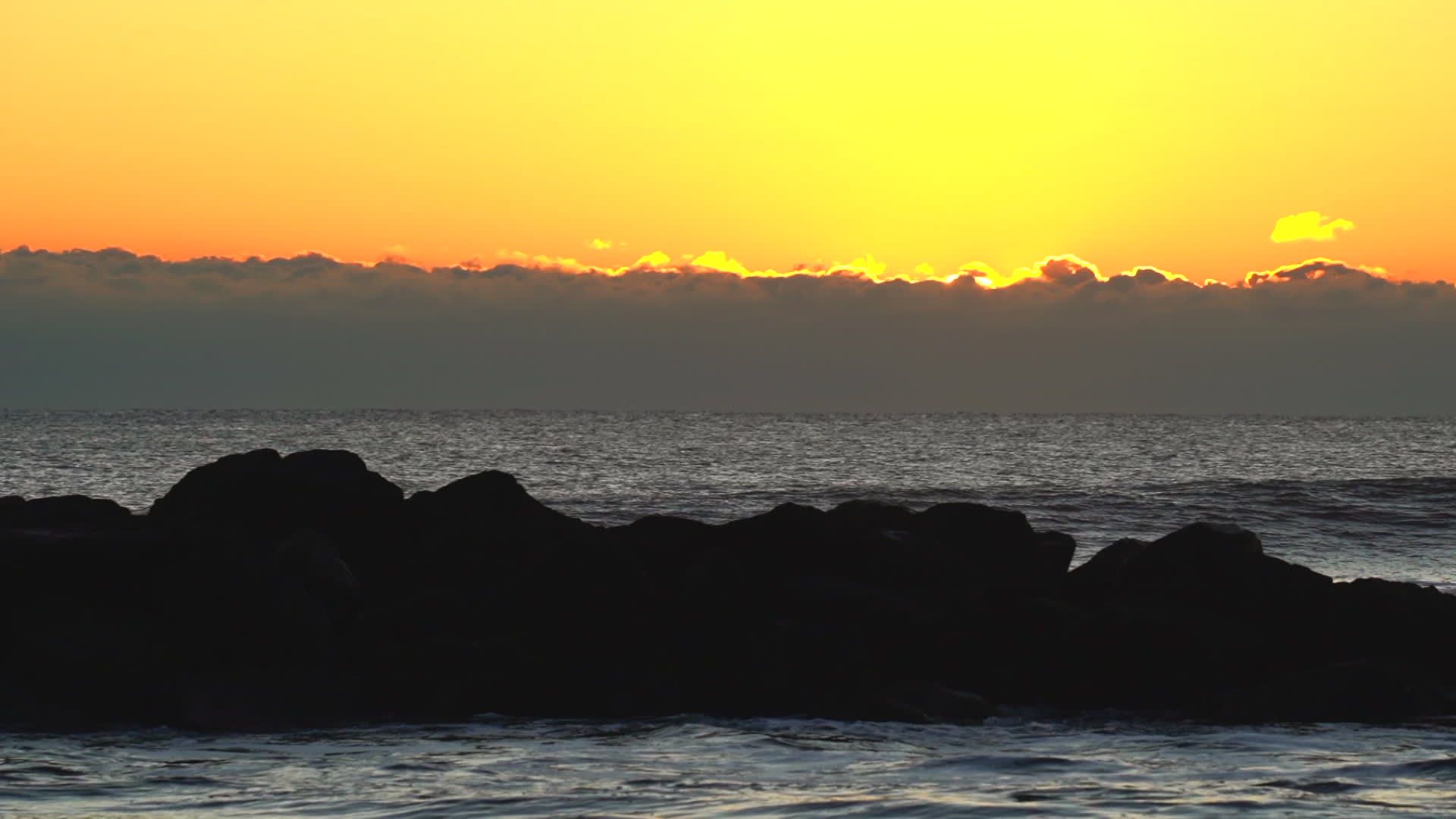 A sunset over the ocean with rocks and water Free Stock Video Footage ...