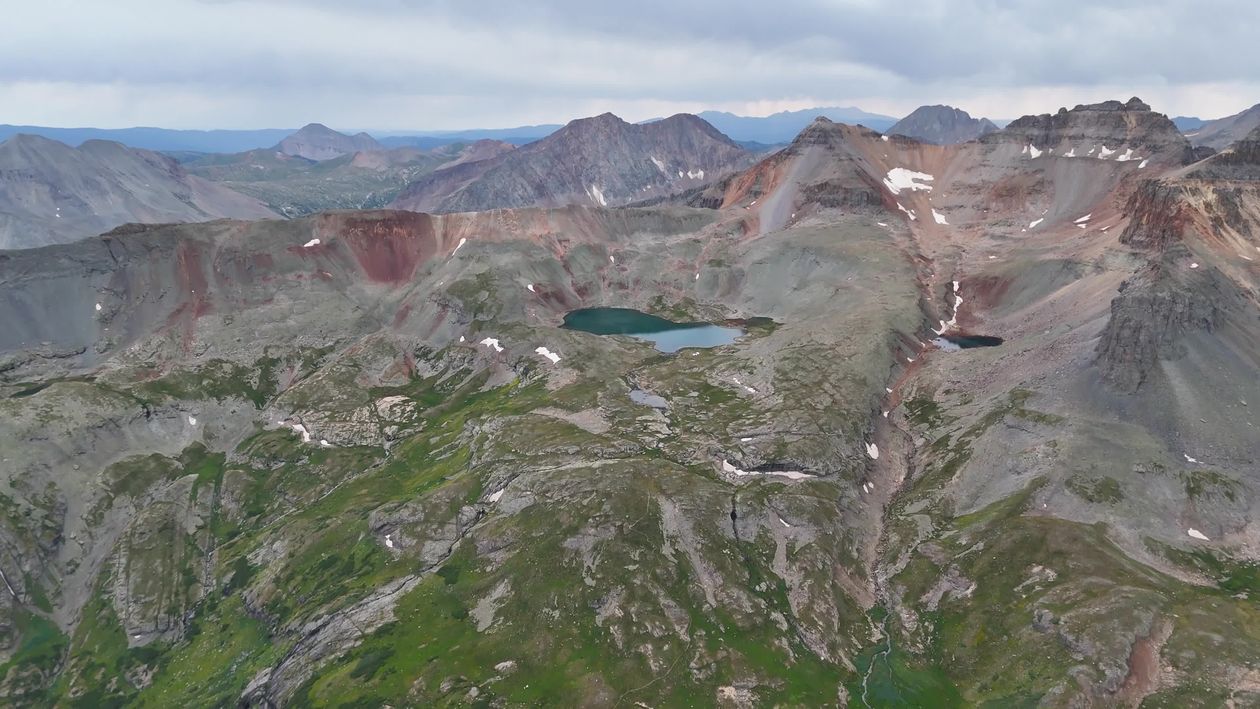 An aerial view of a mountain lake and surrounding mountains Free Stock ...