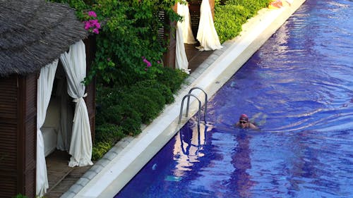 A Woman Swimming In A Pool