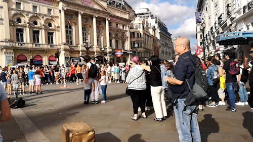 Crowds Of People In The Street Watching Street Performance