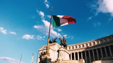 the italian flag flies in front of a building