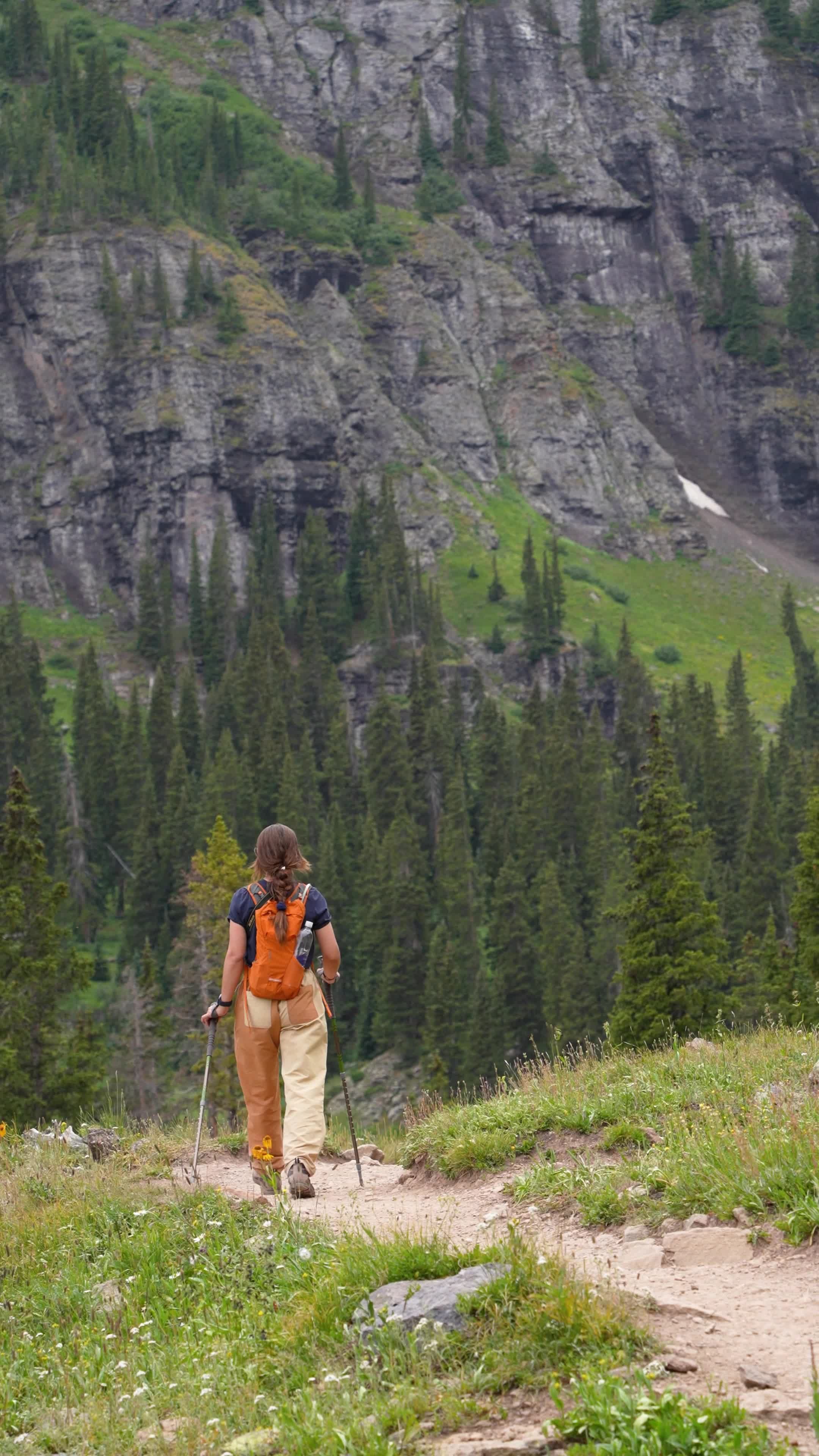 a person walking on a trail in the mountains 27834559