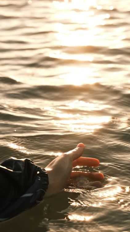 A person's hand in the water with the sun behind it Free Stock Video ...