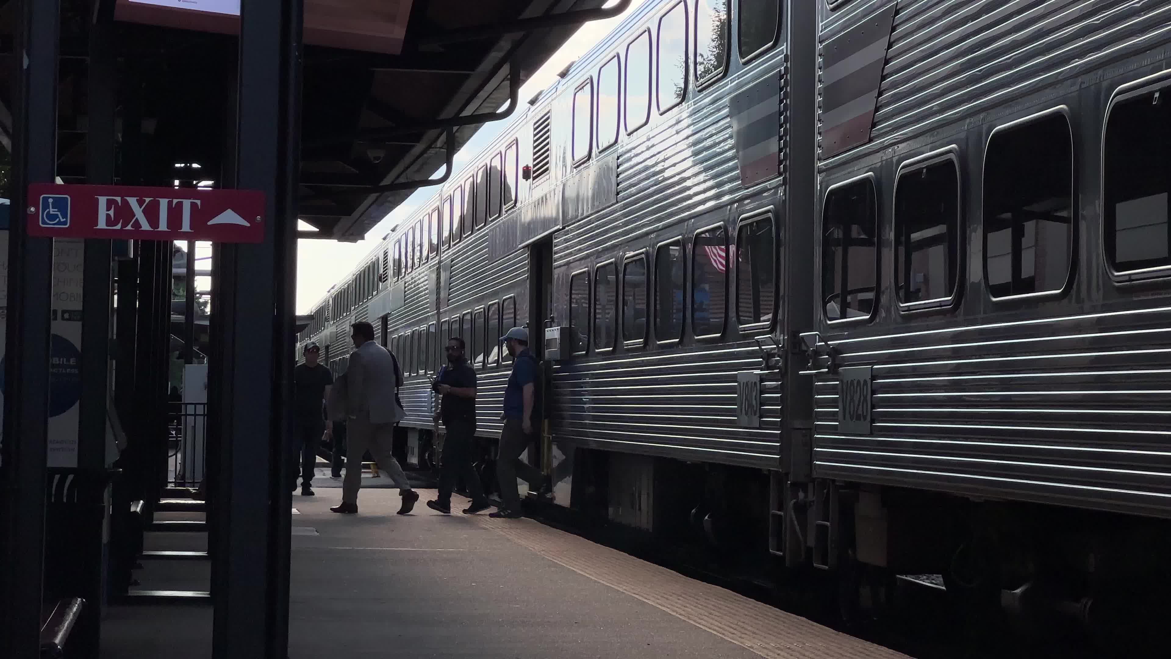 A man with a backpack walks by a train Free Stock Video Footage ...