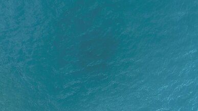 drone flight over the hunza valley a long blue river below with boats and boats with tourists in summer