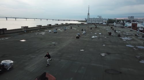 Man Riding On Skateboard On Rooftop