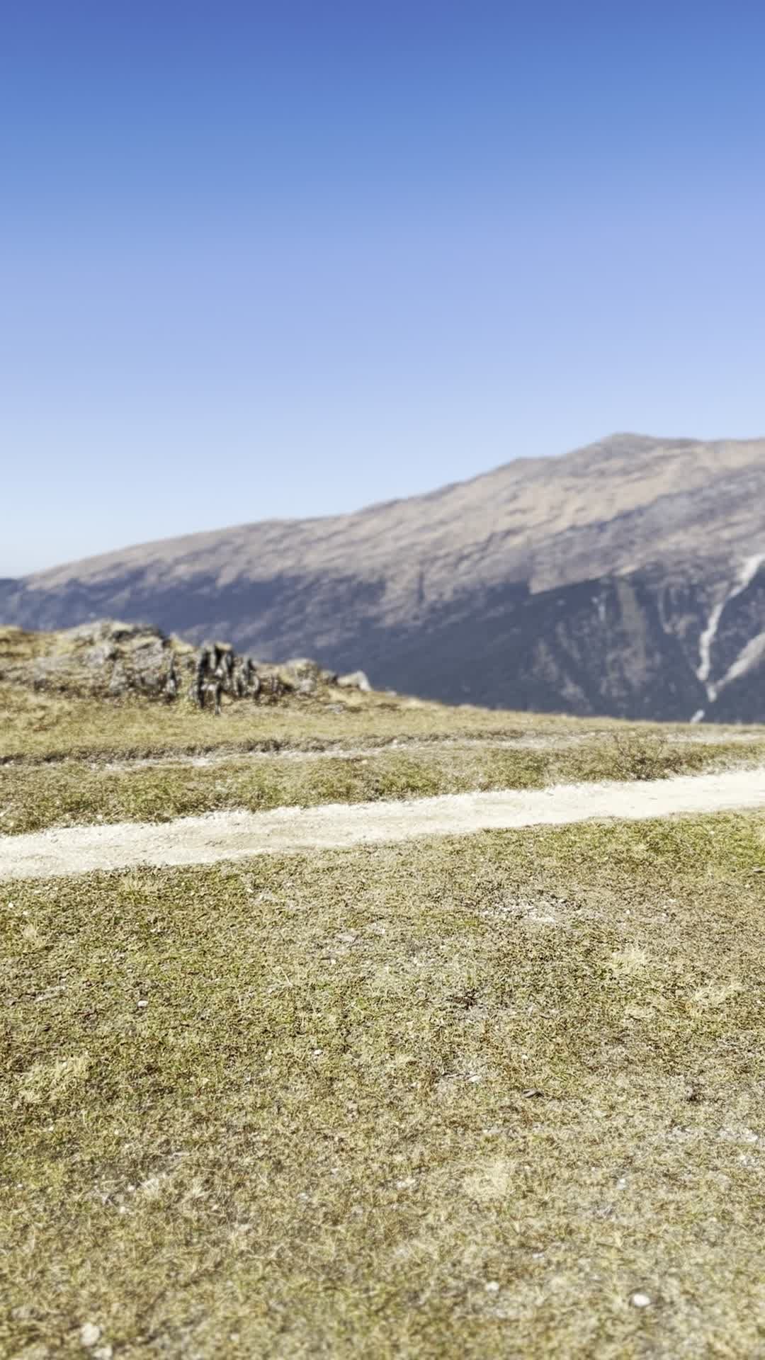a man walking up a hill with a backpack 27946625