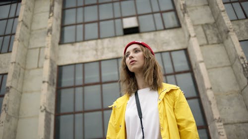 Close-Up View Of A Woman Wearing Red Beanie And Yellow Jacket