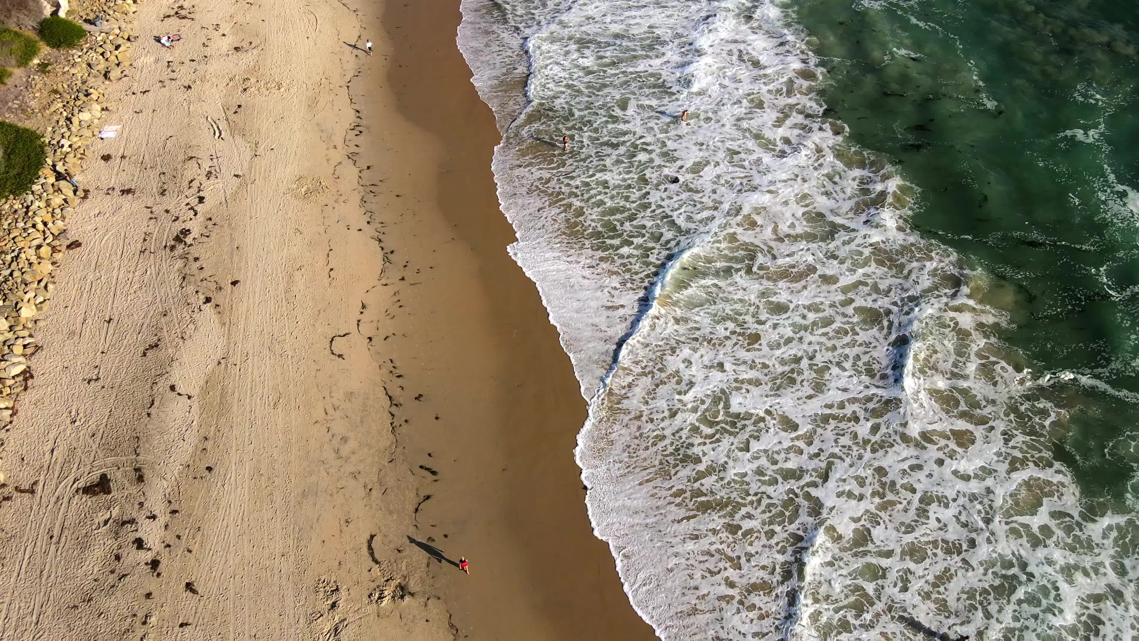 An aerial view of a beach with waves and sand Free Stock Video Footage ...