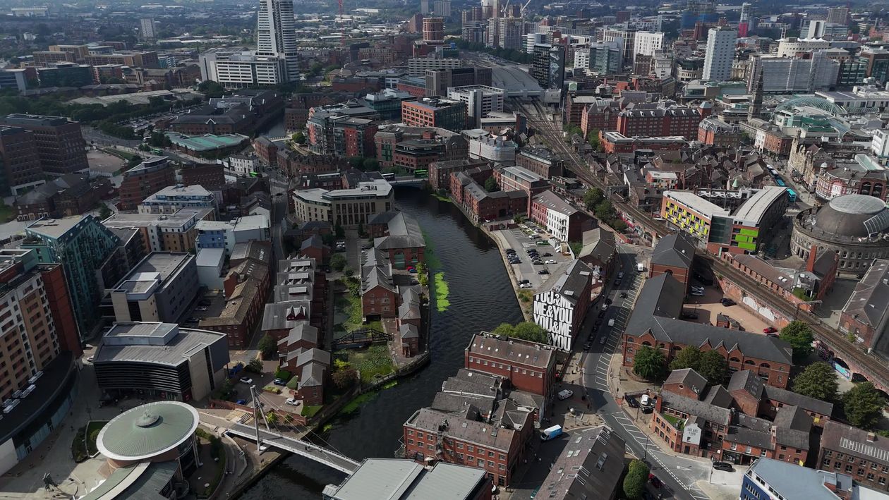 An aerial view of a city with a river and buildings Free Stock Video ...