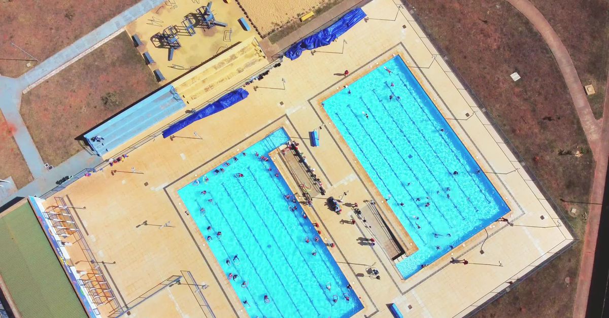 An aerial view of a swimming pool with a large pool Free Stock Video ...