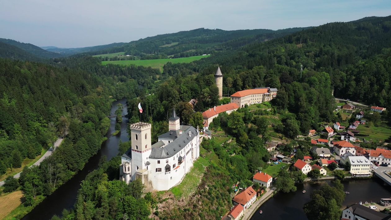 An aerial view of a castle surrounded by trees and water Free Stock ...