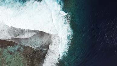 slow motion footage from above of waves breaking on the reefs
