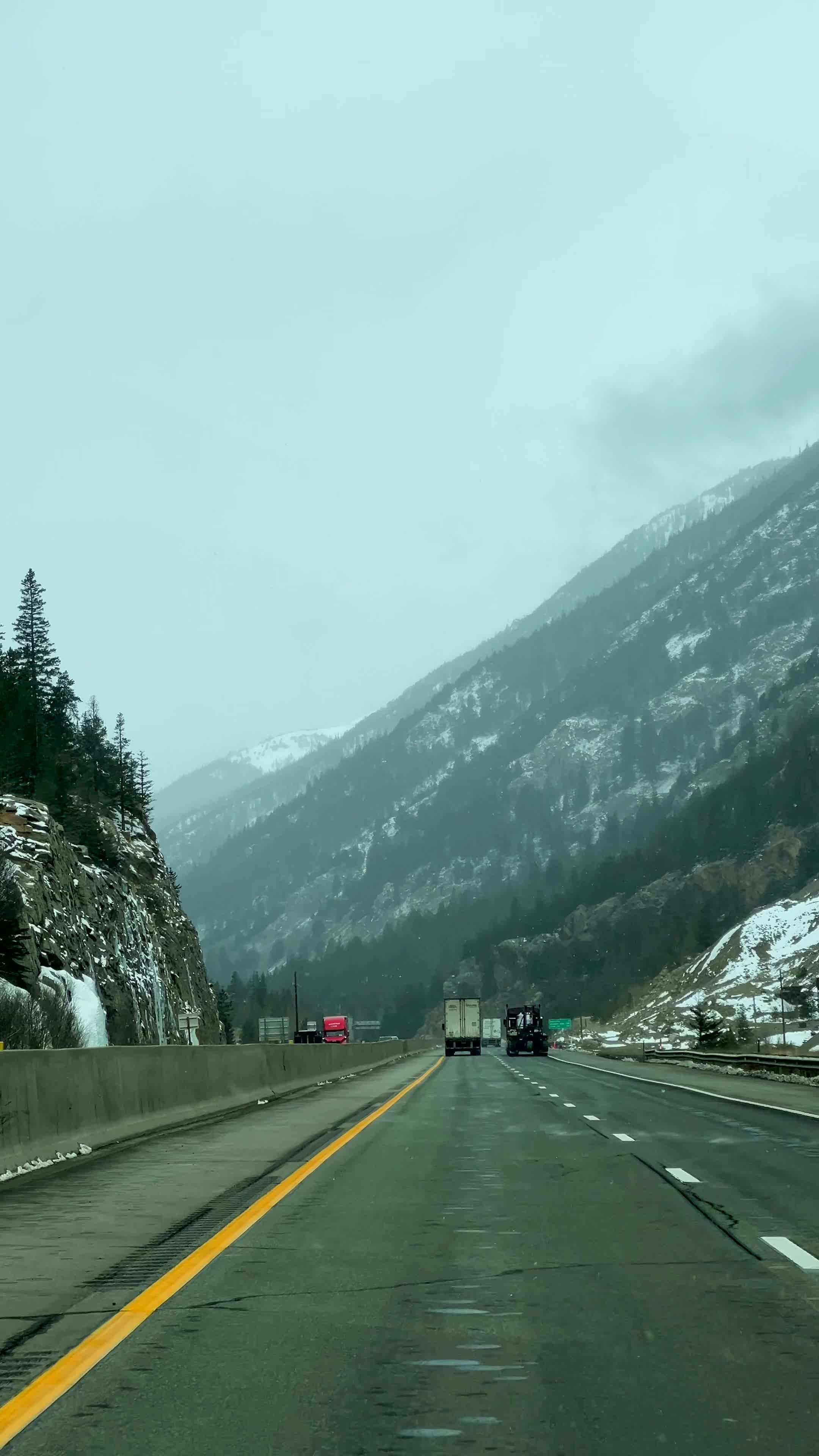 A highway with snow on the ground and trees in the background Free ...