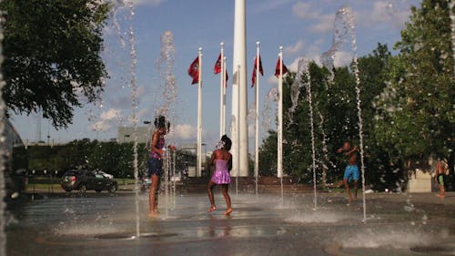 Kids Playing And Getting Wet Playing In A Water Fountain 