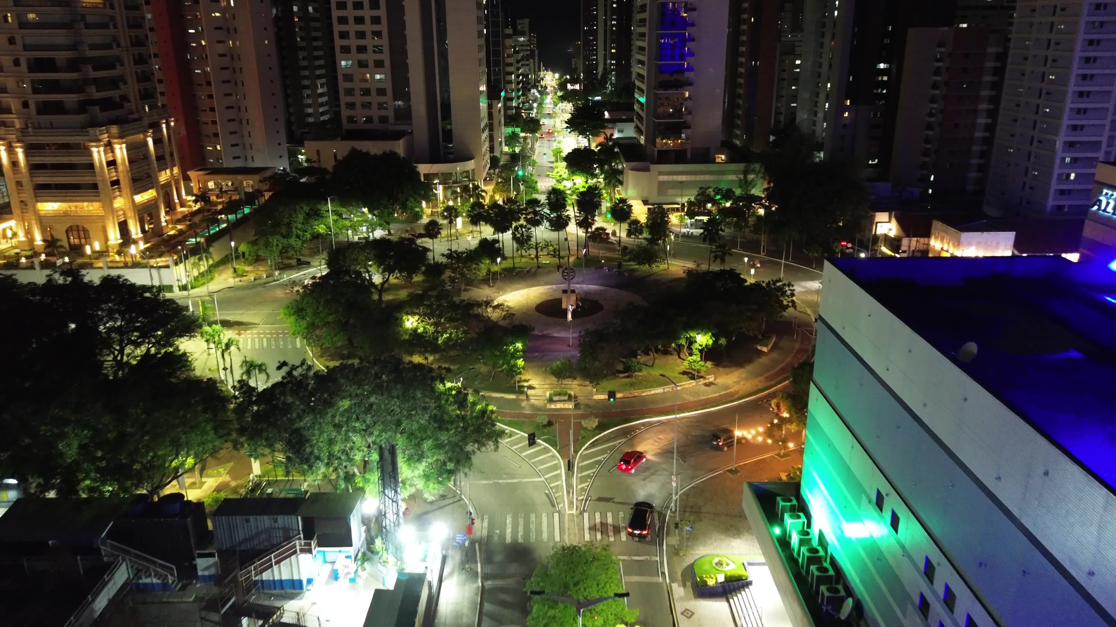A city at night with a fountain in the middle Free Stock Video Footage ...
