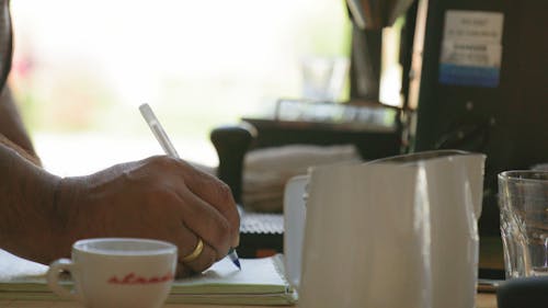 A Man Using A Pen For Writing