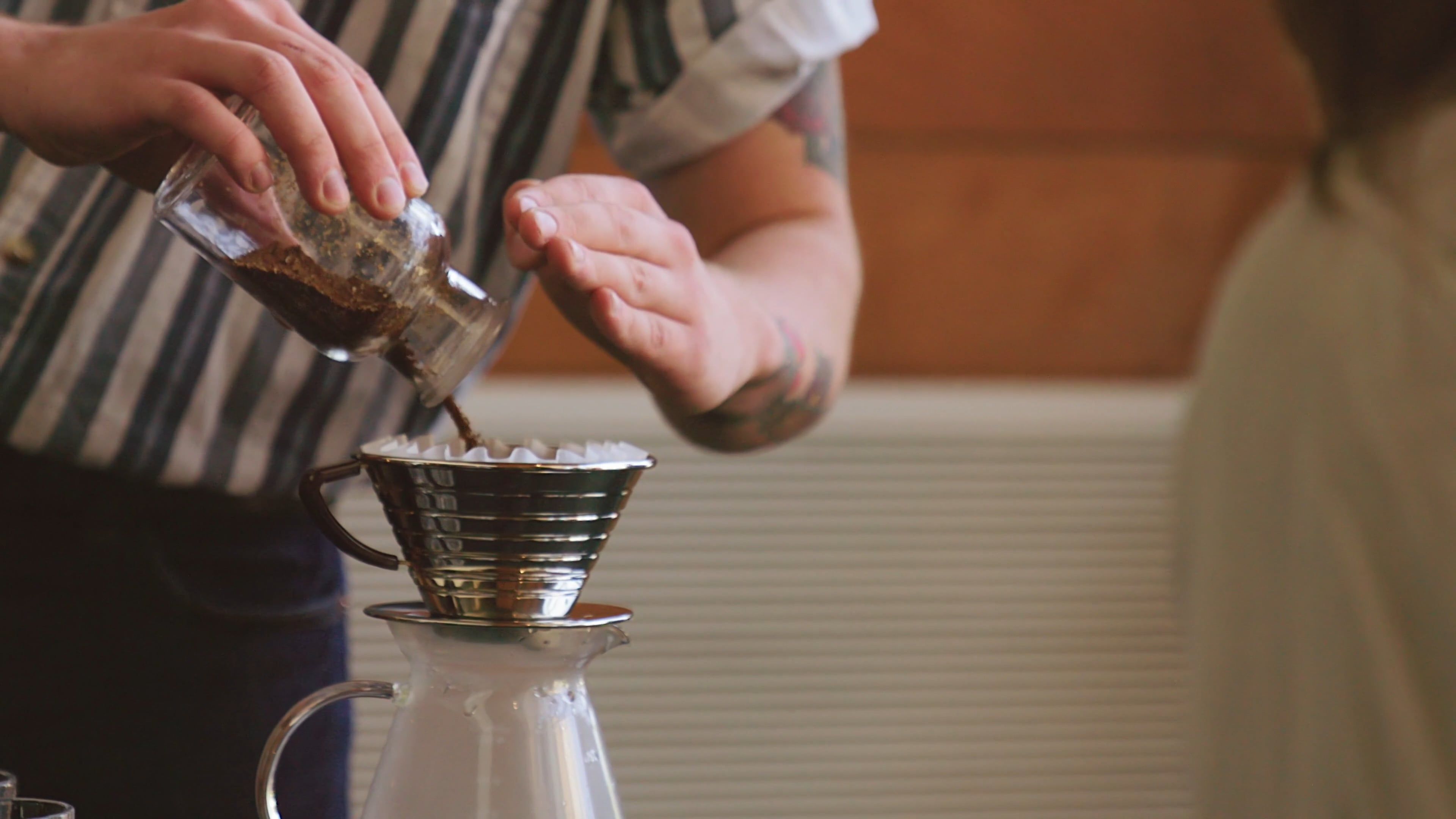 a man pouring ground coffee on a tin cup filter to make hot brewed coffee 2853791 — free pexels stock footage
