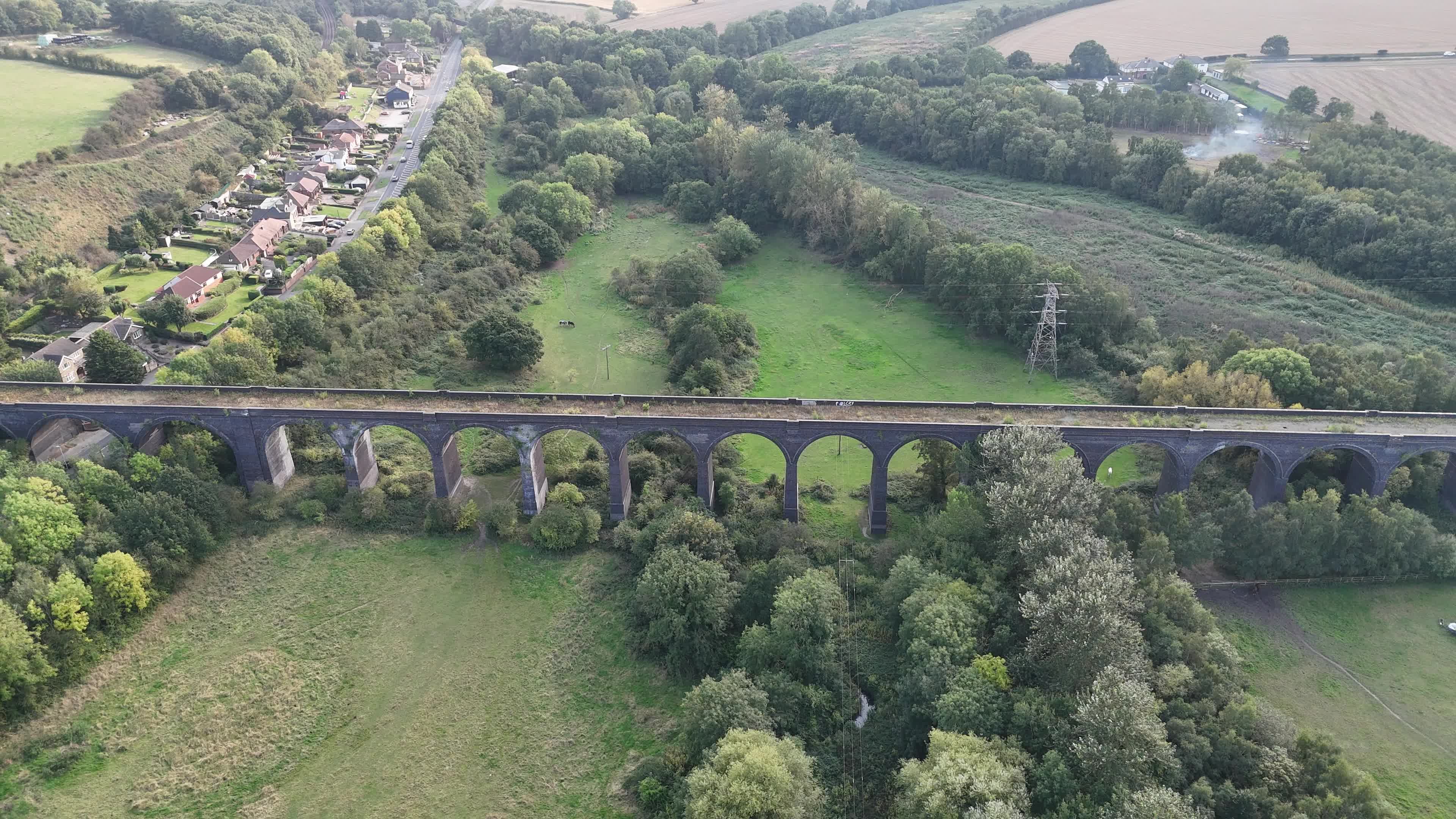 An aerial view of a field with trees and grass Free Stock Video Footage ...