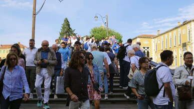 people walking up the stairs of a bridge