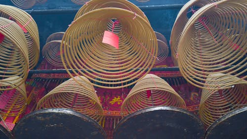 A Lit Spiral Incense Hanging In The Temple 