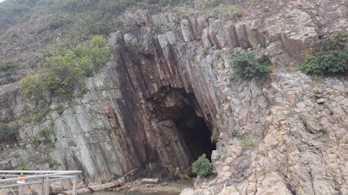 A Large Cave On A Cliff Of A Rocky Mountain