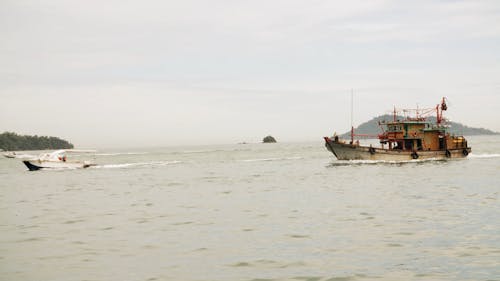 Fishing Boat And Motorboat Travelling