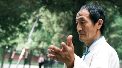 An Old Man Doing Tai Chi For Mental And Physical Health