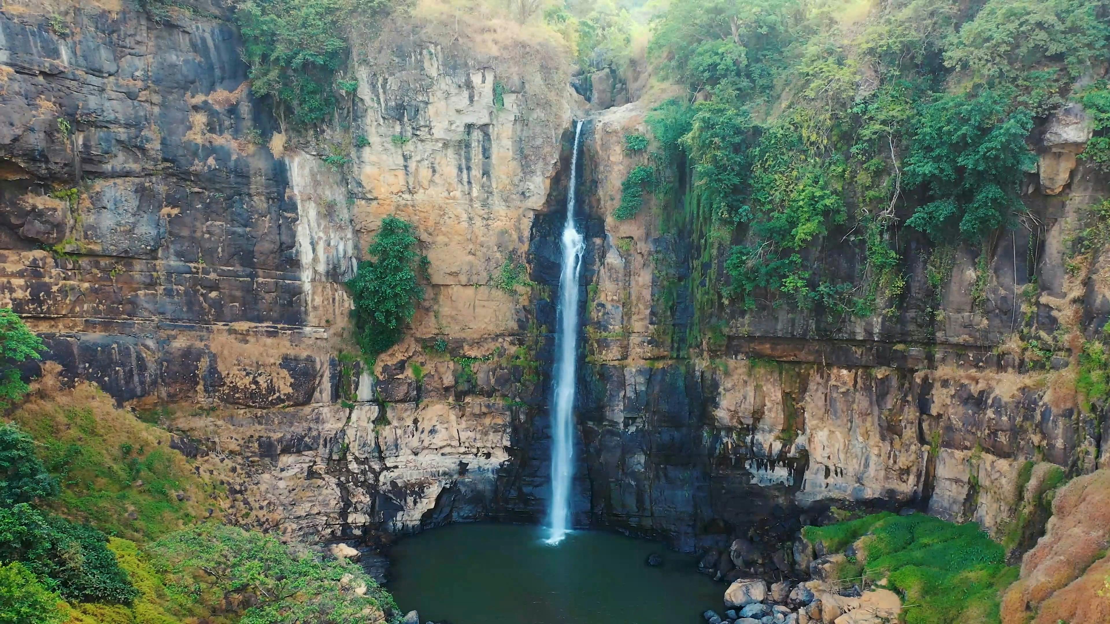 A Tall Waterfall Down Pouring On A Plunge Basin · Free Stock Video