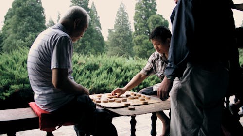 Two Men Playing A Board Game