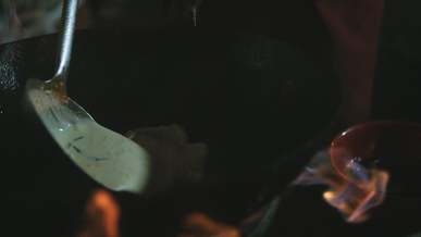 cooking a creamy dish on a wok pan