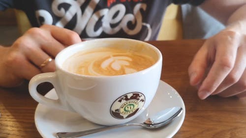 A Man Sip On A Hot Cup Of Coffee