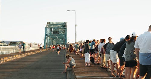 People Enjoying Their Day In A Walking Bridge