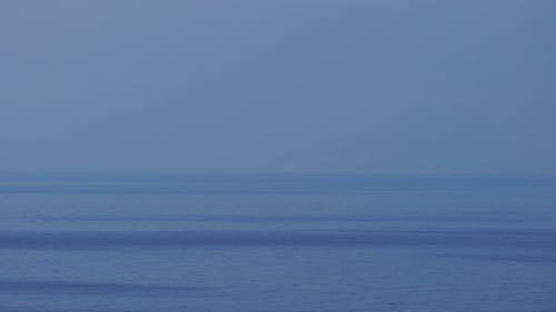 Blue Sky And Blue Water In The Horizon