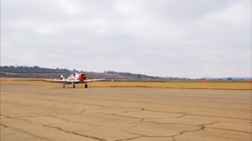 Pilot Of A Single Engine Airplane Waving His Hand After Landing