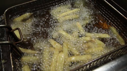 Deep Frying Cut Potatoes In Boiling Oil