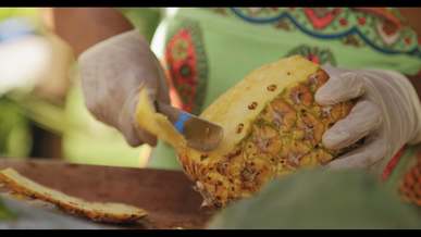 peeling a pineapple with knife