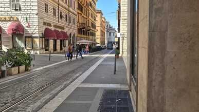charming rome street with passing tramway