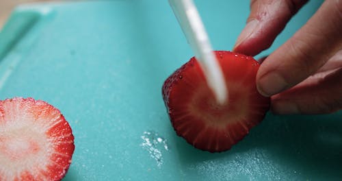 Cutting Into Pieces A Strawberry Fruit