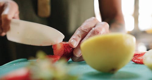 Slicing Strawberry Fruits Into Pieces