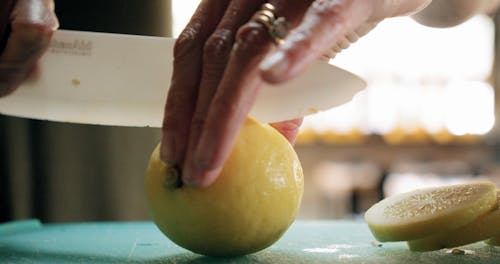 Slicing A Lemon Using A Plastic Knife