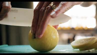slicing a lemon using a plastic knife