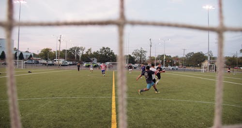 A Game Of Soccer Being Played By A Group Of Men