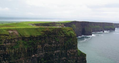 People Visits A Lighthouse Ruined Overlooking The Sea